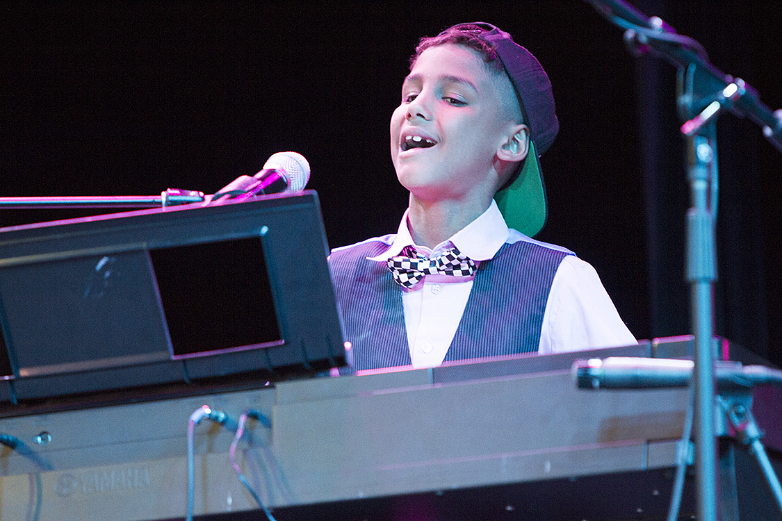 A Triumph student sings and plays keyboards at a Triumph gig.